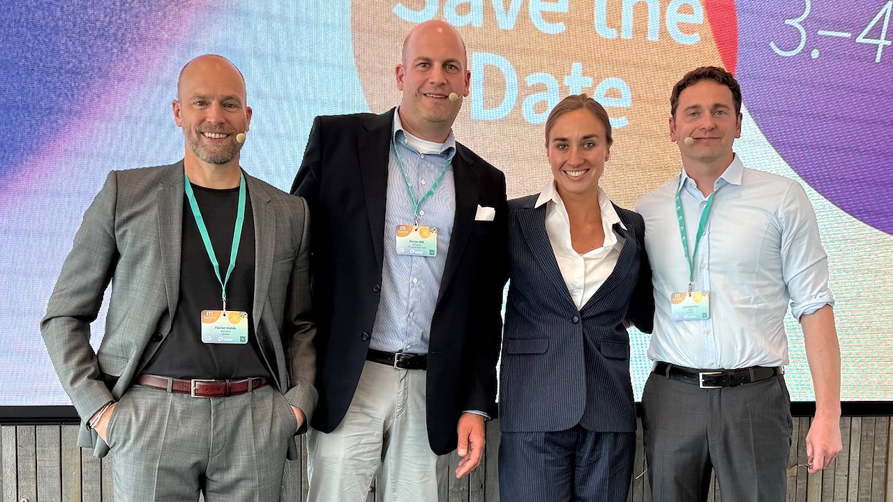 Prof. Dr. Dr. Florian Stelzle, Dr. Florian Will, Dr. Elisabeth Prause und Prof. Dr. Jeremias Hey stehen vor der Vortragswand.